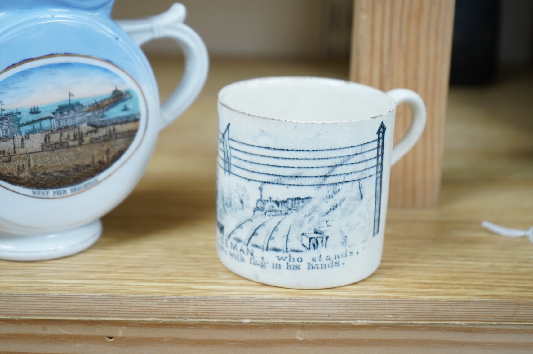 A 19th century Policeman mug and an early 20th century Brighton West Pier jug, 13cm